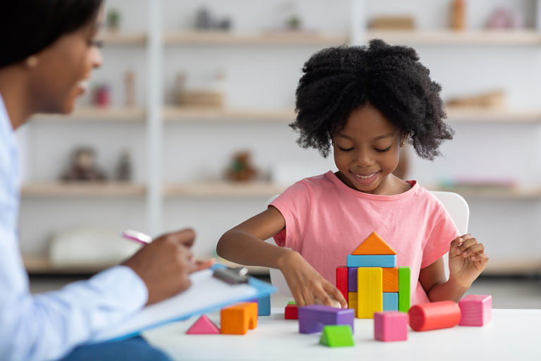 Child psychologist working with a young girl