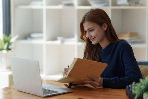 Bachelor's in Counseling Psychology student studying online with notebook