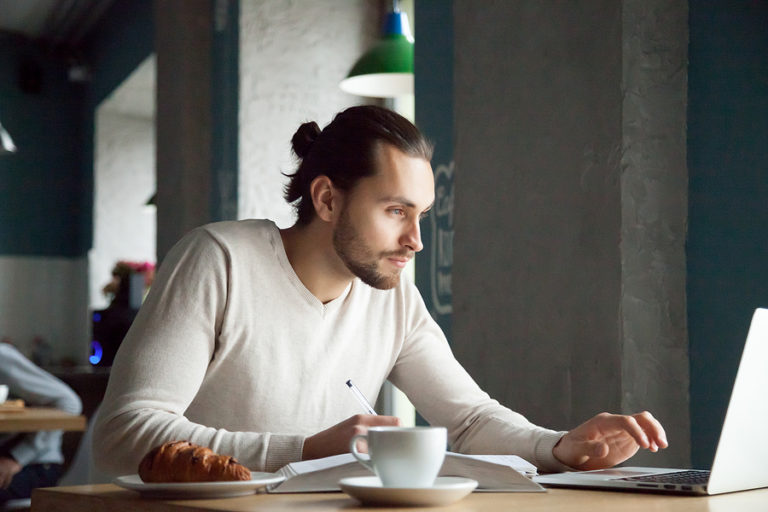 Man completing a school counseling graduate certificate online