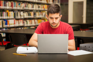Student at laptop enrolling in a bachelor's in psychology program