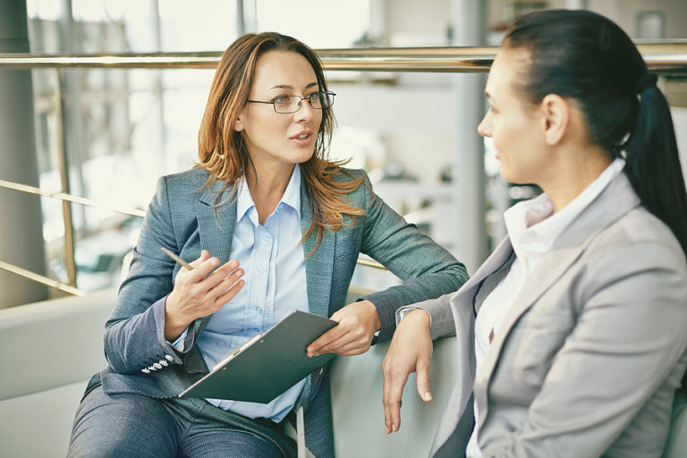 Industrial-Organizational Psychologist in a business office having a meeting with an employee