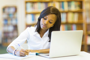 Social work student studying at laptop