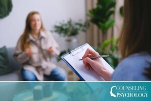 A social psychologist sits with a patient in an office and takes notes.