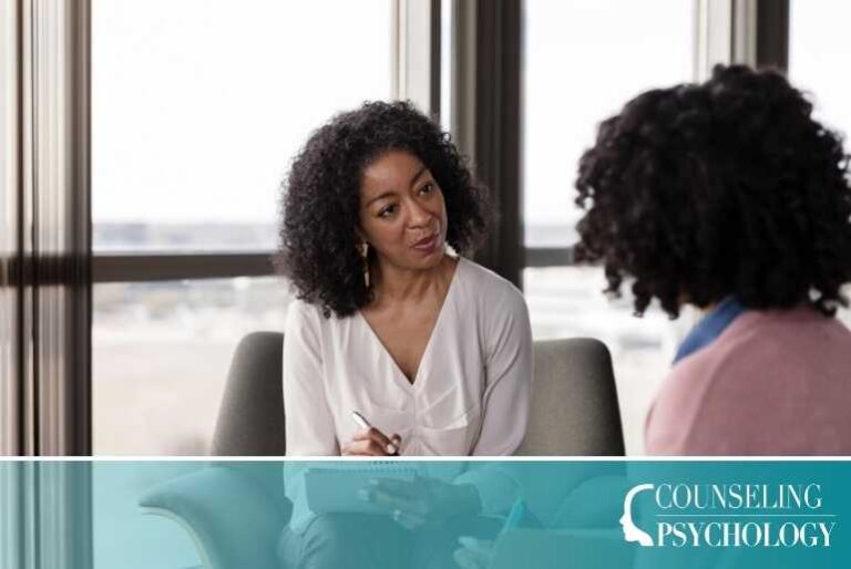 An addictions counselor meets with a patient in her office.