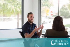 A psychology degree graduate furthers his career by doing some clinical work with a patient.