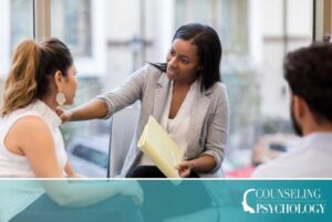 An addictions counselor works with a couple in her office.