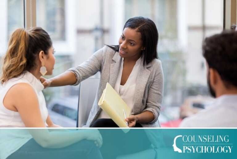 An addictions counselor works with a couple in her office.